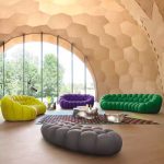 A playful bubble football-inspired cream sofa combining inflatable aesthetics with modular lounge functionality, crafted from tear-resistant TPU and eco-friendly memory foam for dynamic living spaces.