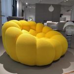 A playful bubble football-inspired cream sofa combining inflatable aesthetics with modular lounge functionality, crafted from tear-resistant TPU and eco-friendly memory foam for dynamic living spaces.