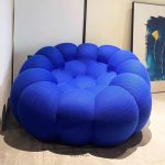 A playful bubble football-inspired cream sofa combining inflatable aesthetics with modular lounge functionality, crafted from tear-resistant TPU and eco-friendly memory foam for dynamic living spaces.
