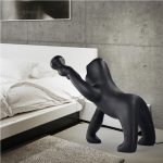 A sculptural gorilla-shaped floor lamp merging artistic expression with functional lighting, crafted from industrial-grade metal and adjustable LED panels for modern interiors.