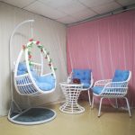 Elevate your outdoor space with a trendy wicker hanging chair.
