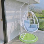 Elevate your outdoor space with a trendy wicker hanging chair.