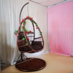 Elevate your outdoor space with a trendy wicker hanging chair.