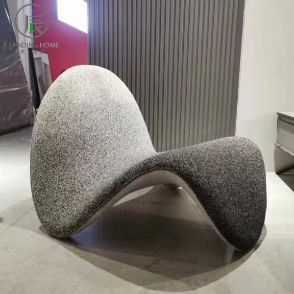 Instagram-famous tongue-shaped chair merges ergonomic curves with vegan leather comfort, becoming a provocative yet functional art piece for trendy spaces.