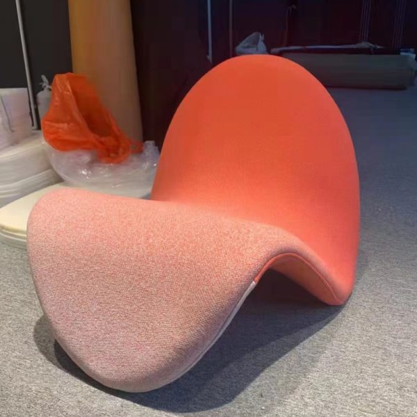 Instagram-famous tongue-shaped chair merges ergonomic curves with vegan leather comfort, becoming a provocative yet functional art piece for trendy spaces.