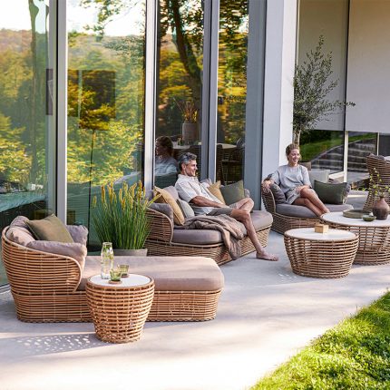 Create a cozy outdoor nook with a sofa.