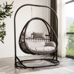 Relax in style with an outdoor hanging wicker chair.