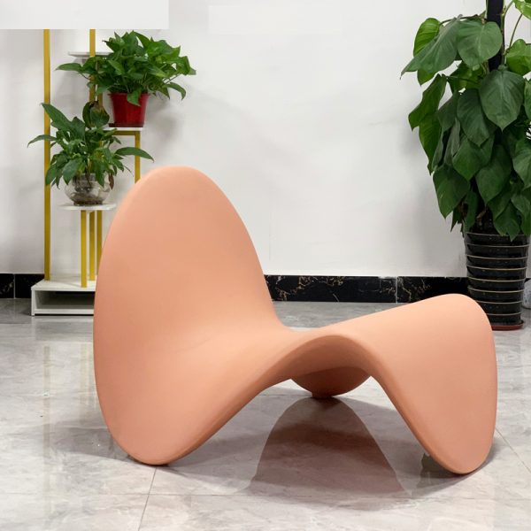 Instagram-famous tongue-shaped chair merges ergonomic curves with vegan leather comfort, becoming a provocative yet functional art piece for trendy spaces.