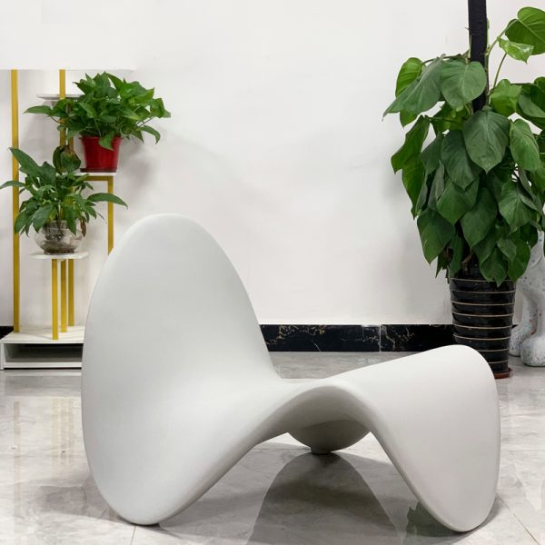 Instagram-famous tongue-shaped chair merges ergonomic curves with vegan leather comfort, becoming a provocative yet functional art piece for trendy spaces.