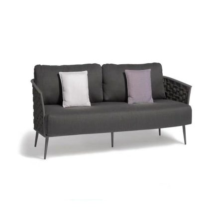 Create a cozy outdoor nook with a sofa.